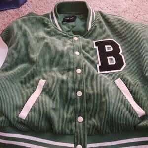 Green jacket and beige sleeves with B on it
